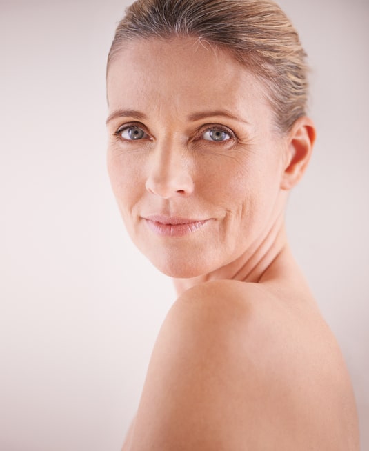 Cropped studio shot of a beautiful mature woman looking over her shoulder